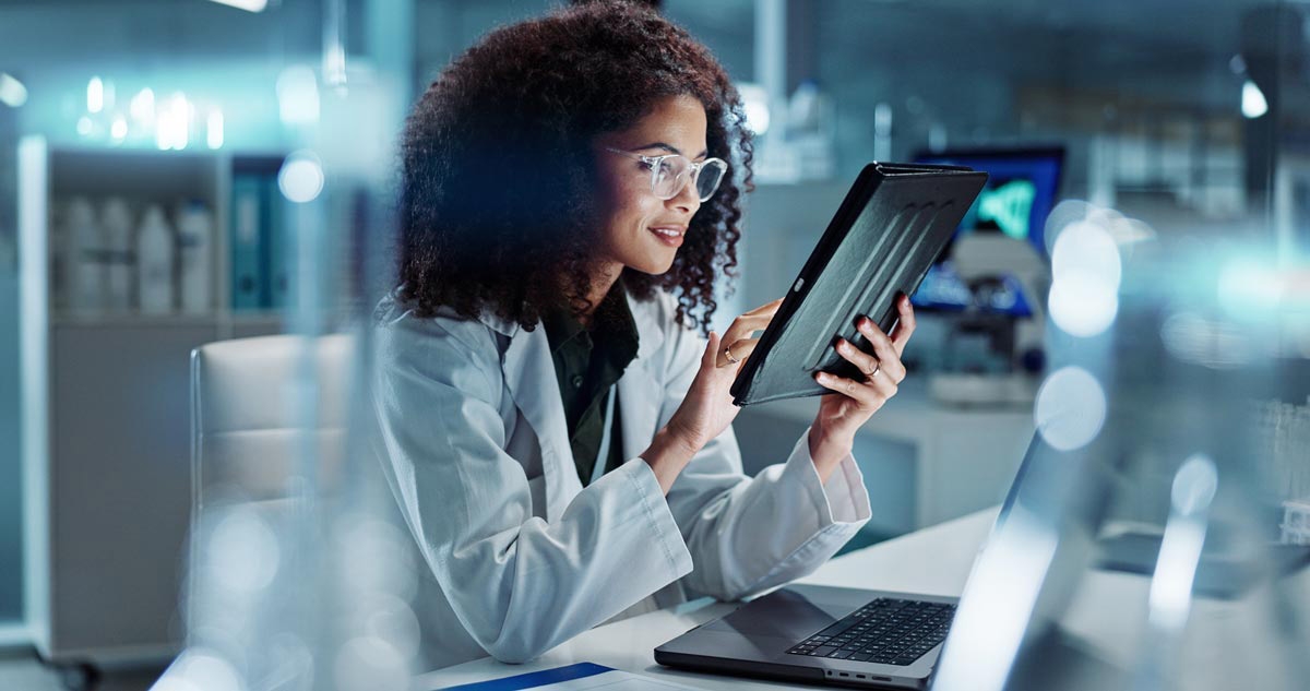 Tablet, laptop and woman scientist in lab working on medical research, project or experiment. Science, career and female researcher with digital technology and computer for pharmaceutical innovation. Tablet, laptop and woman scientist in lab working on medical research, project or experiment. Science, career and female researcher with digital technology and computer for pharmaceutical innovation.