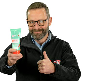 Thorsten Fries, Abteilungsleiter Service Center, hält sein Lieblingsprodukt Pferdesalbe in die Kamera
